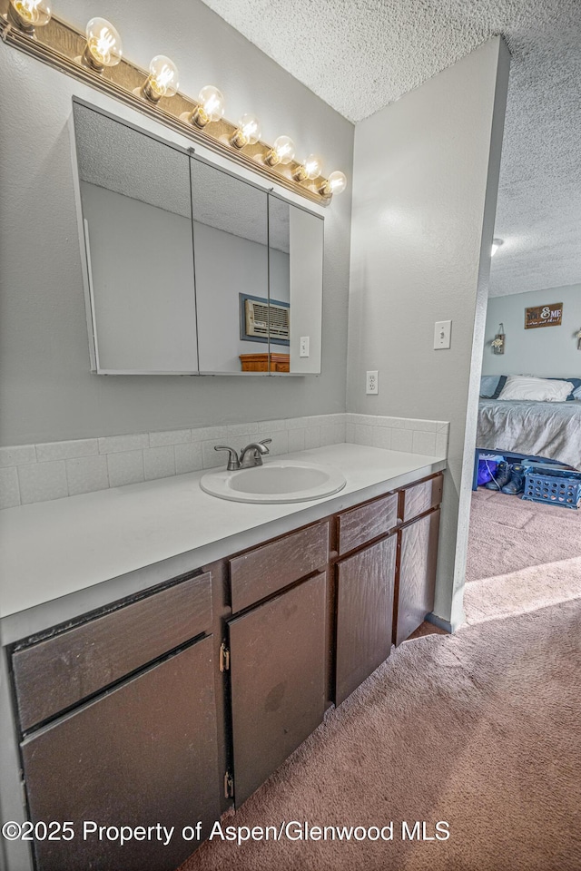 bathroom with a textured ceiling and vanity