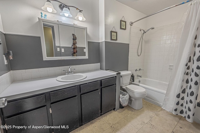 full bathroom with toilet, vanity, and shower / bath combo with shower curtain