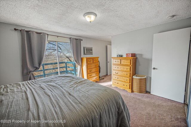 carpeted bedroom with a textured ceiling