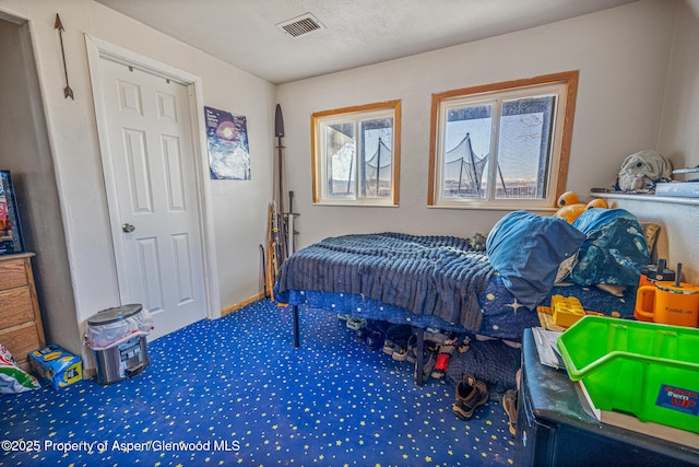 bedroom featuring visible vents and carpet flooring