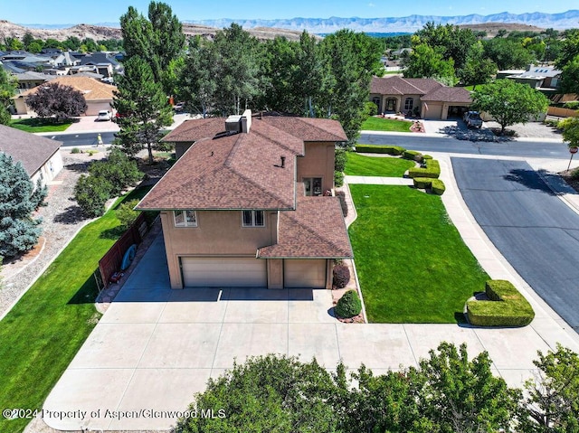 drone / aerial view featuring a residential view and a mountain view