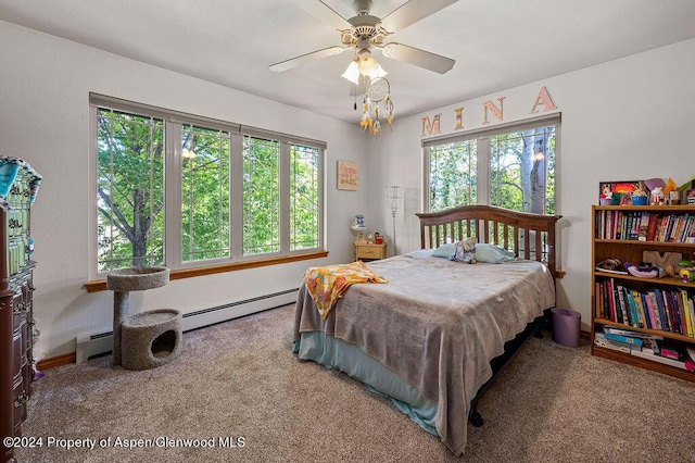 carpeted bedroom with baseboard heating, multiple windows, and a ceiling fan