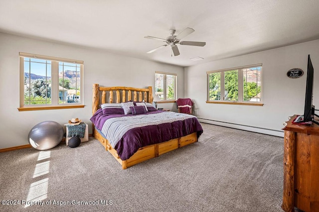 bedroom with a ceiling fan and a baseboard radiator