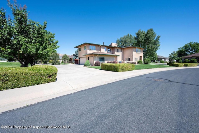 view of front of home with driveway and an attached garage