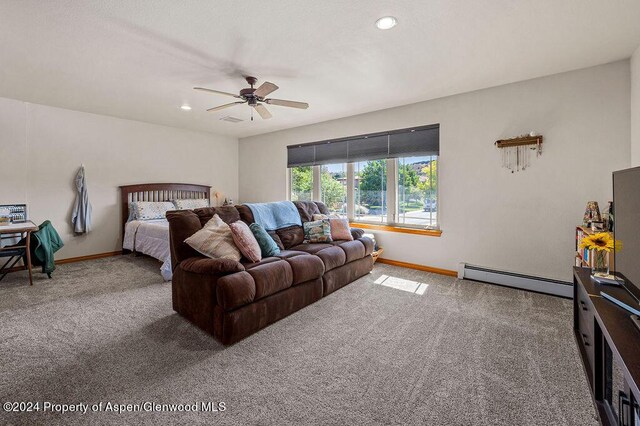 bedroom with baseboards, baseboard heating, and carpet