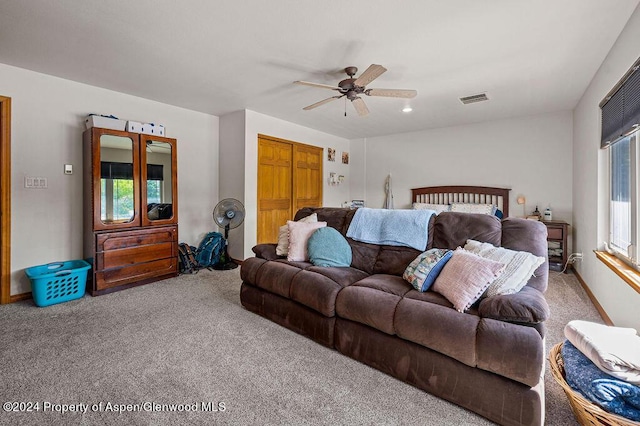 bedroom featuring visible vents, a ceiling fan, a closet, and carpet flooring