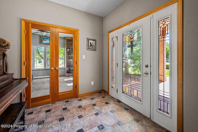 entrance foyer with stone finish floor, french doors, baseboards, and a baseboard radiator