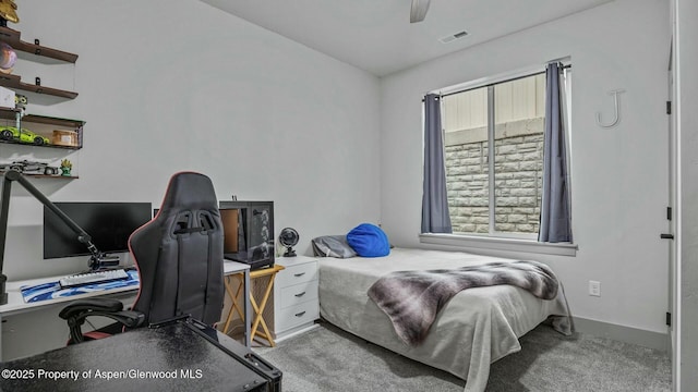 carpeted bedroom featuring a ceiling fan, visible vents, and baseboards