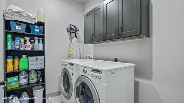 laundry room with independent washer and dryer, wood finished floors, and cabinet space