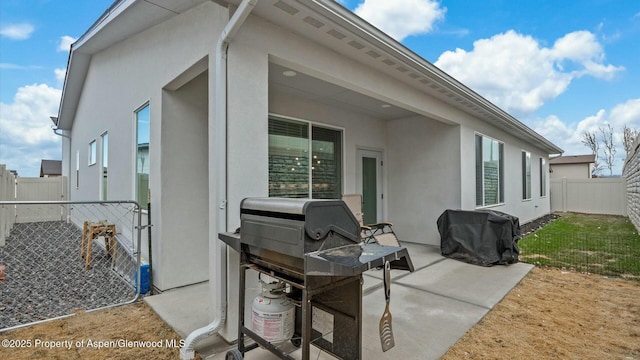 view of patio / terrace featuring a fenced backyard and a grill