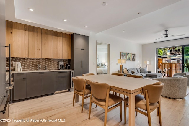 dining space featuring beverage cooler, recessed lighting, light wood-style flooring, and a ceiling fan