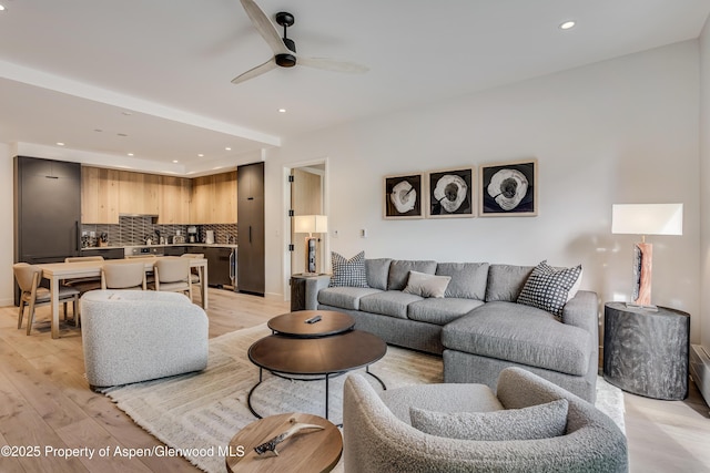 living room featuring light wood-style flooring, recessed lighting, and ceiling fan