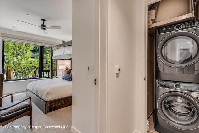 washroom with stacked washer / dryer, laundry area, ceiling fan, and carpet floors