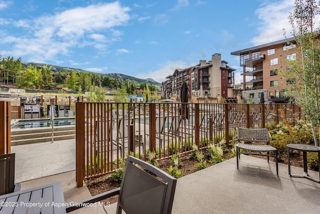 balcony with a mountain view and a patio area