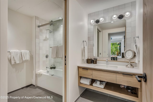 bathroom featuring tile patterned floors, shower / washtub combination, vanity, and baseboards