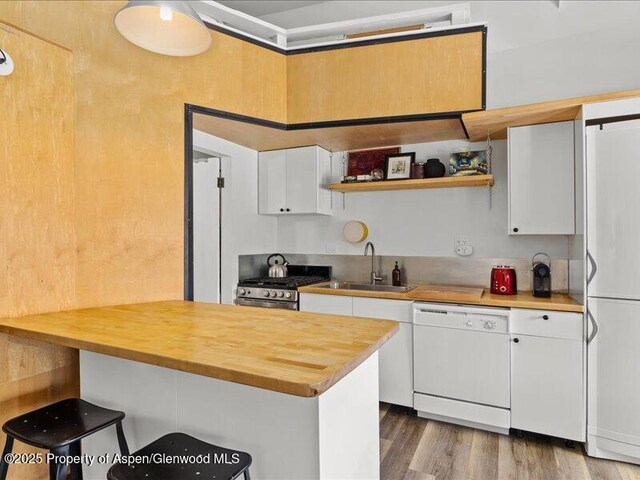 412 Mill St # B9, Aspen, CO 81611 - kitchen featuring white appliances, butcher block counters, and a sink