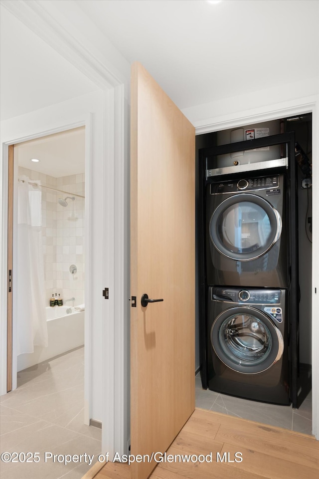 119 Wood Rd Unit 604, Snowmass Village, CO 81615 - washroom featuring stacked washer and clothes dryer and light tile patterned floors