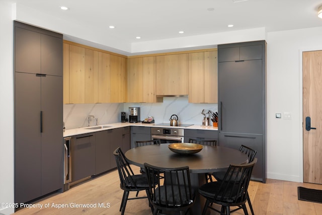 119 Wood Rd Unit 604, Snowmass Village, CO 81615 - kitchen featuring stainless steel oven, gray cabinets, light wood finished floors, light countertops, and recessed lighting