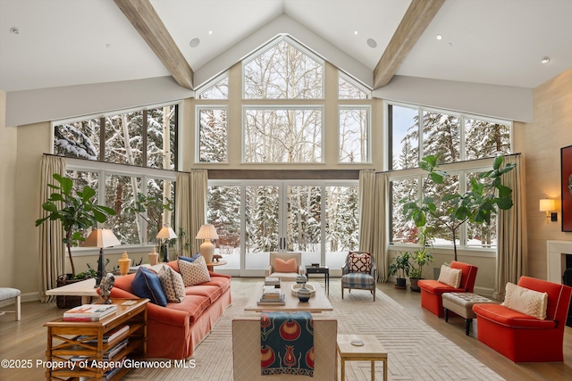 interior space featuring high vaulted ceiling, beam ceiling, and a fireplace