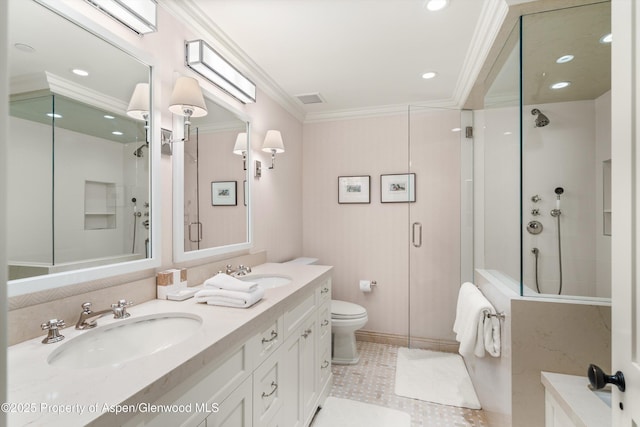 bathroom featuring ornamental molding, a stall shower, and a sink