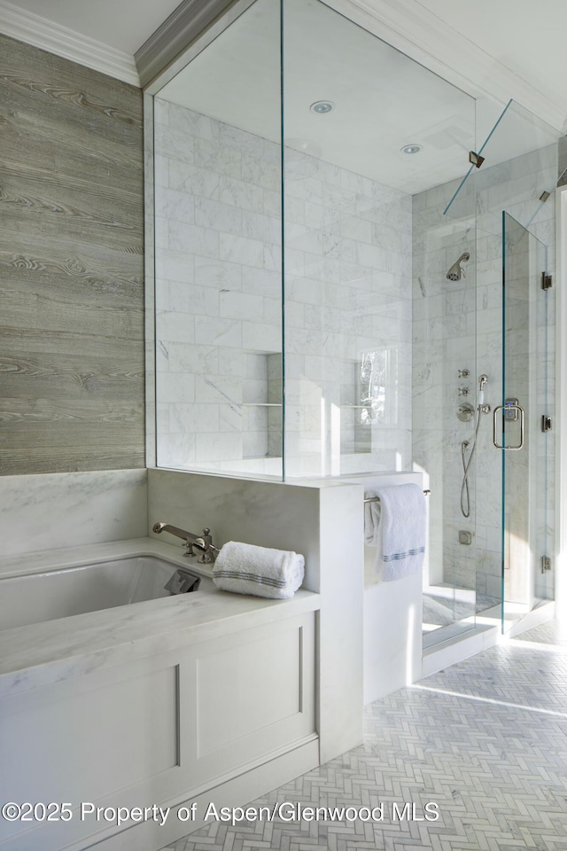 bathroom featuring a stall shower, crown molding, and a bath