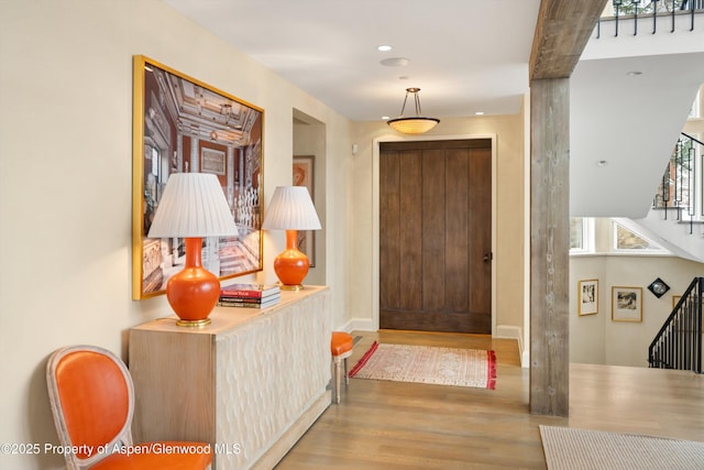 entryway featuring stairs and wood finished floors