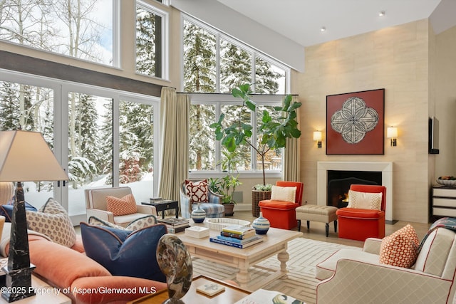 interior space with plenty of natural light, a fireplace, and a high ceiling