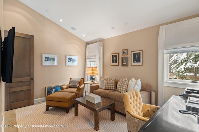 living area featuring lofted ceiling, plenty of natural light, baseboards, and recessed lighting