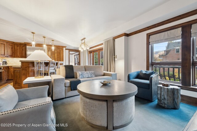 living room with vaulted ceiling and a notable chandelier