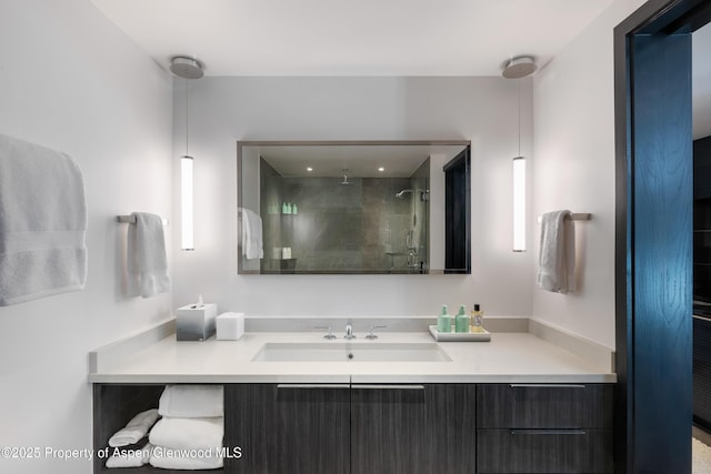 bathroom featuring an enclosed shower and vanity