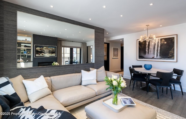 living room featuring hardwood / wood-style flooring, a chandelier, and a fireplace