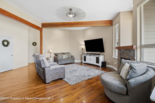 1783 Anvil View Ave, Rifle, CO 81650 - living area featuring wood finished floors, ceiling fan, a stone fireplace, beamed ceiling, and recessed lighting