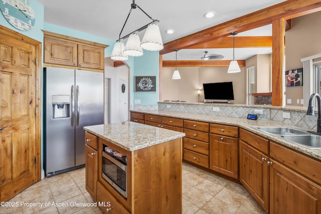 1783 Anvil View Ave, Rifle, CO 81650 - kitchen with stainless steel appliances, beam ceiling, decorative light fixtures, recessed lighting, and brown cabinets