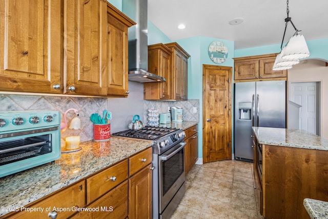 1783 Anvil View Ave, Rifle, CO 81650 - kitchen featuring appliances with stainless steel finishes, wall chimney exhaust hood, and brown cabinetry