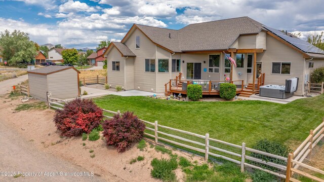1783 Anvil View Ave, Rifle, CO 81650 - back of house with a fenced backyard, a hot tub, a patio, a wooden deck, and a storage unit