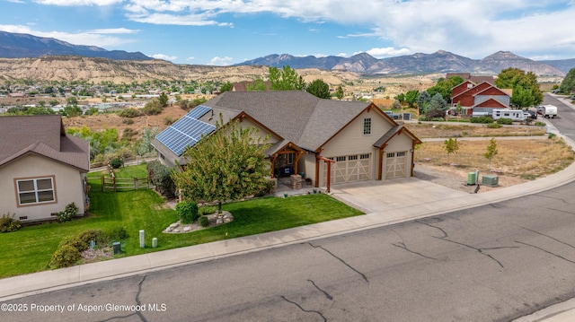 1783 Anvil View Ave, Rifle, CO 81650 - view of front of property with a mountain view, concrete driveway, solar panels, and a garage