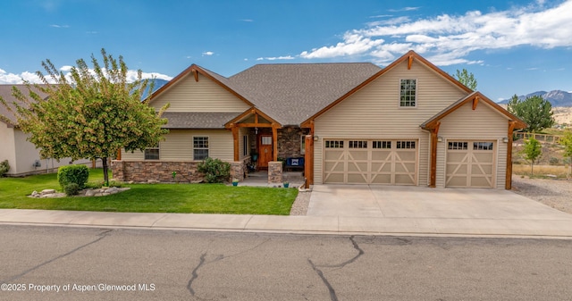 1783 Anvil View Ave, Rifle, CO 81650 - view of front of home with roof with shingles, a mountain view, driveway, a front lawn, and stone siding