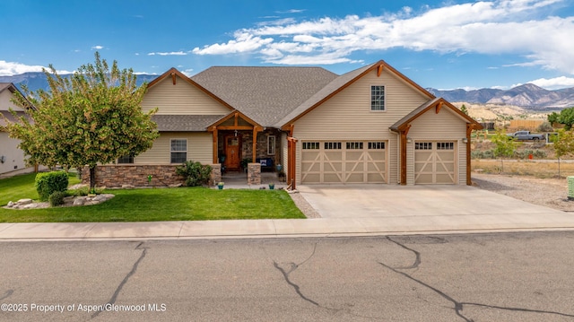 1783 Anvil View Ave, Rifle, CO 81650 - view of front of property featuring a mountain view, concrete driveway, a front yard, a garage, and roof with shingles