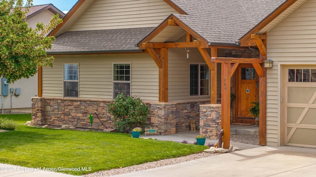1783 Anvil View Ave, Rifle, CO 81650 - view of front facade with a shingled roof, stone siding, a front lawn, and a garage