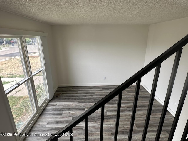 3865 W 6th St, Craig, CO 81625 - stairway with a textured ceiling and wood finished floors