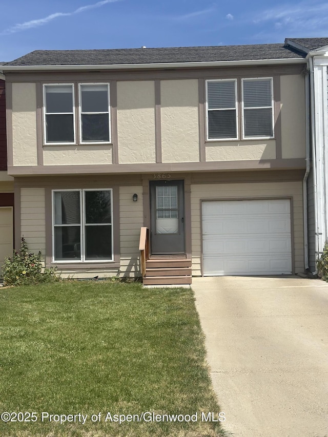 3865 W 6th St, Craig, CO 81625 - multi unit property with a garage, stucco siding, a front yard, driveway, and entry steps