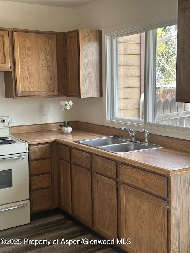 3865 W 6th St, Craig, CO 81625 - kitchen featuring white range with electric cooktop, brown cabinetry, and light countertops