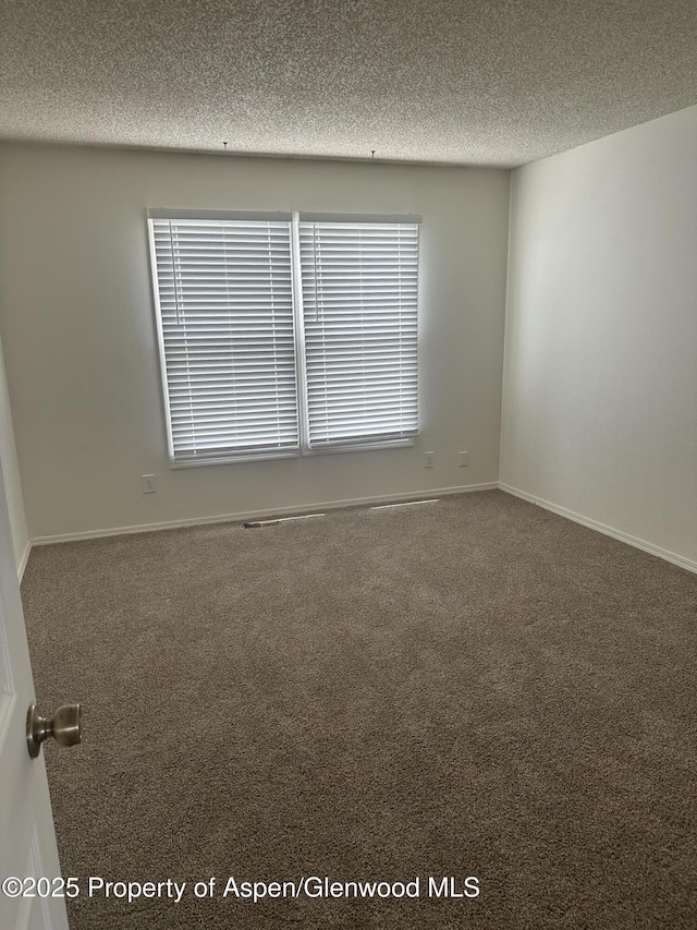 3865 W 6th St, Craig, CO 81625 - carpeted spare room with a textured ceiling and baseboards