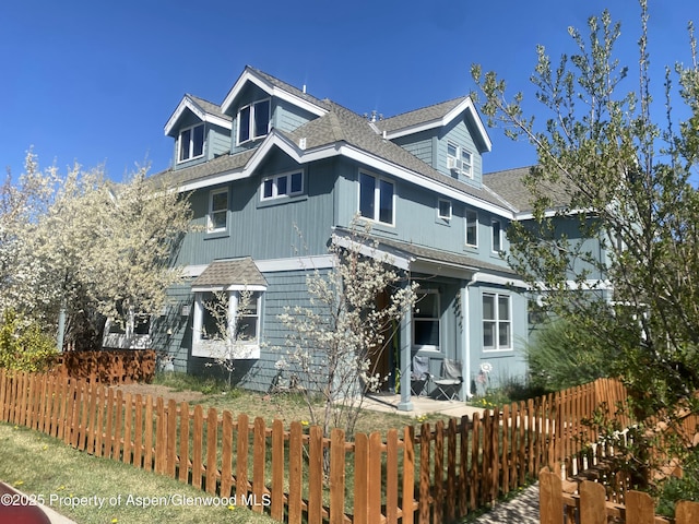 287 Southside Dr, Basalt, CO 81621 - view of home's exterior with a fenced front yard and roof with shingles