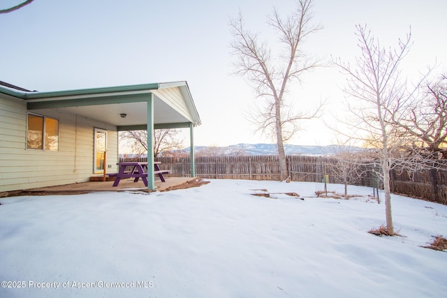 snowy yard featuring a mountain view