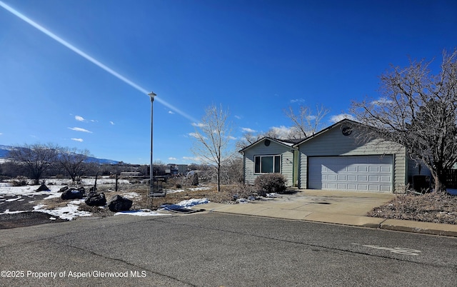 view of front of property with a garage and a mountain view