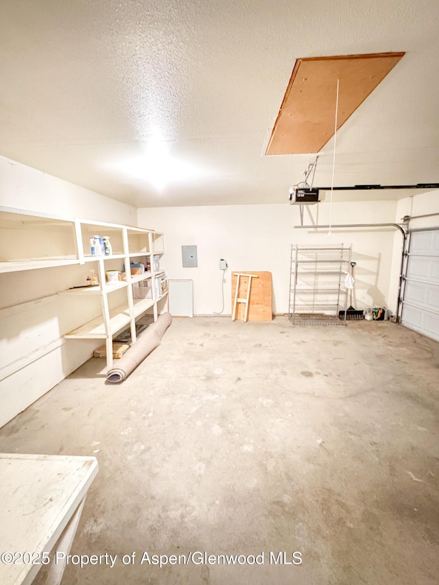 interior space with a textured ceiling and electric panel