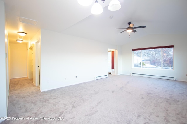 carpeted empty room with vaulted ceiling, ceiling fan, and a baseboard heating unit