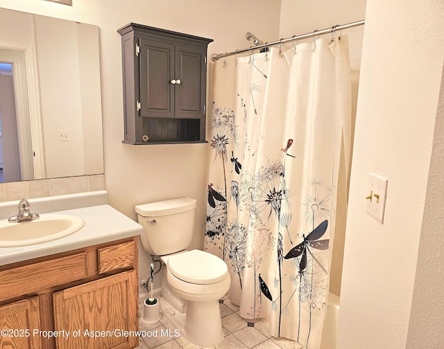 bathroom featuring toilet, tile patterned flooring, and vanity