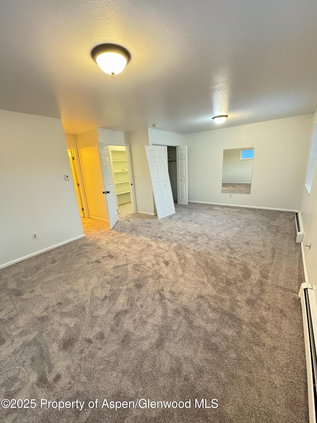 interior space featuring baseboard heating and a textured ceiling